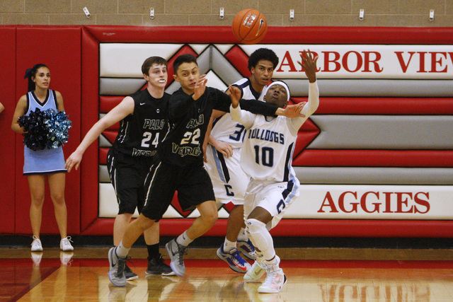 Palo Verde guard Taylor Miller, left, and Centennial guard Isaiah Banks chase a rebound on T ...