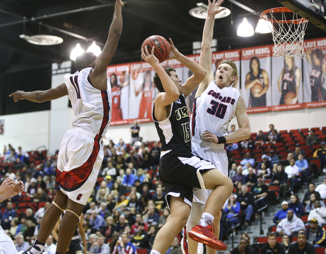 Clark guard James Bridges (15) drives to the basket against Coronado’s Will Weems (11) ...