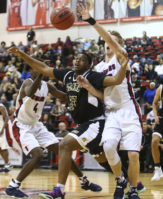 Clark forward Antwon Jackson (23) and Coronado’s Kennedy Koehler (30) fight for a rebo ...