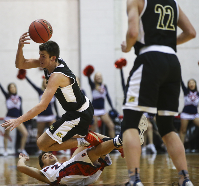 Clark guard James Bridges (15) saves the ball while tripping over Coronado’s Patrick S ...