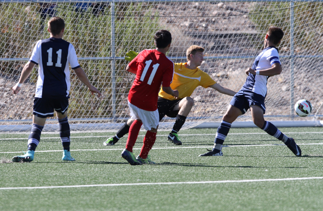 Valley’s Marco Gonzales (11) shoots the ball past Foothill goalie Derek Lawson (00) du ...