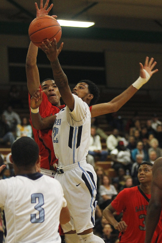 Canyon Springs’ Shaquile Carr (23) gets his shot off past Las Vegas’ Tyler Bey ( ...