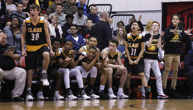 Clark players react during the first half of a Class 4A boys state final game at the Cox Pav ...