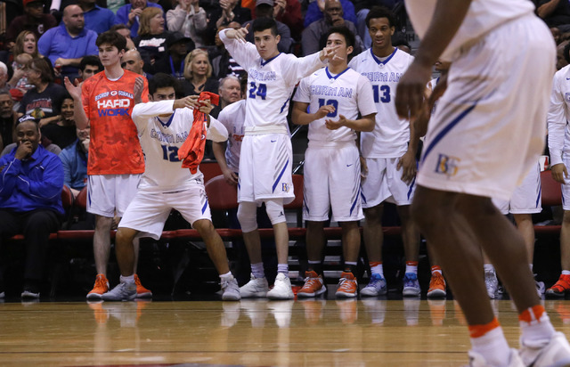 Bishop Gorman players react after one their teammates scores against Clark during the second ...