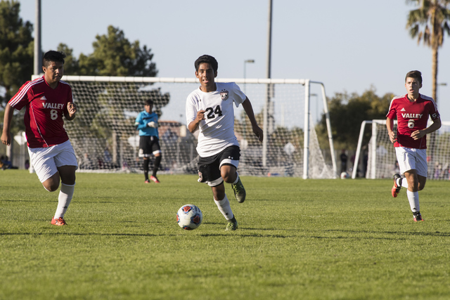 Jair Jaimes-Ponce advances the ball through Valley defenders Andy Gonzales (8) and Fausto Ve ...