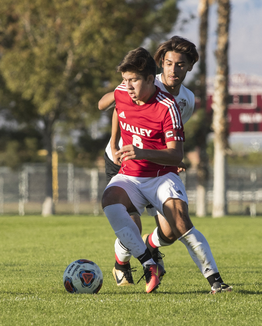 Fausto Vega (6) battles for the ball against Alejandro Graciano (14), from Las Vegas High Sc ...