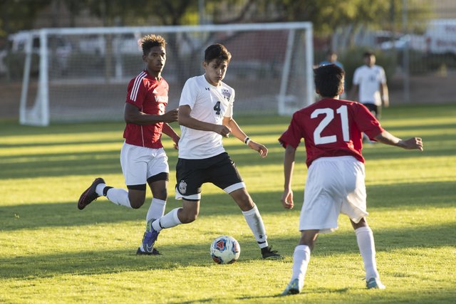 Jonathan Macedo-Castellano (4), from Las Vegas High School, moves the ball up field through ...