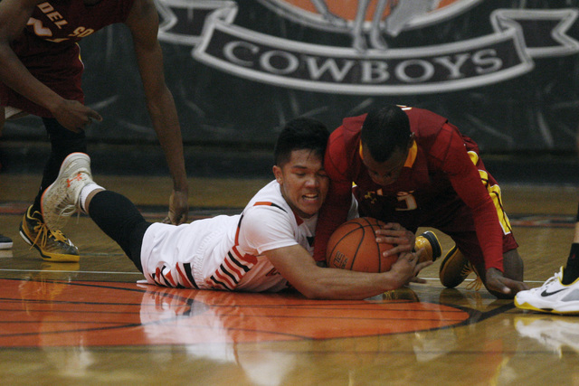 Chaparral guard Jerome Williamson and Del Sol guard Rashaun Lawson fight for a loose ball on ...