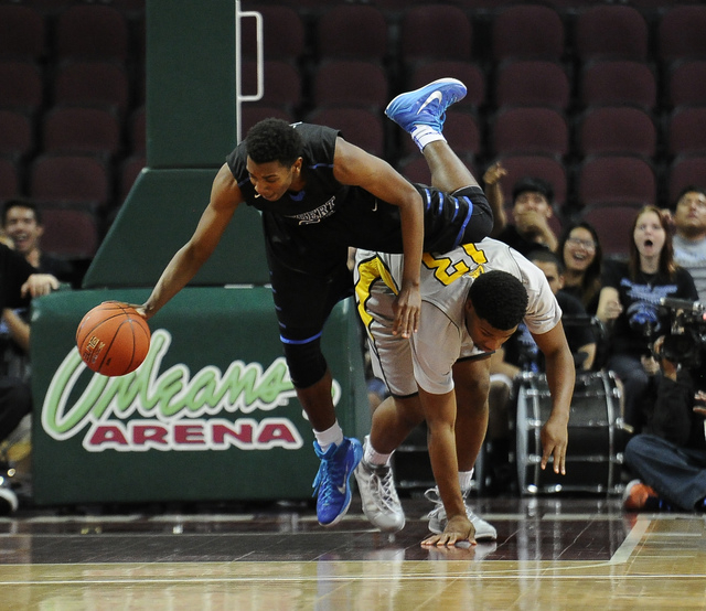 Desert Pines guard Jordan Simon (2) is tripped up by Clark forward Ty’Rek Wells in the ...