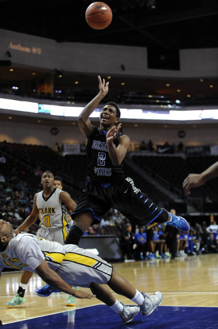 Desert Pines guard Jordan Simon (2) is fouled by Clark forward Ty’Rek Wells in the fir ...