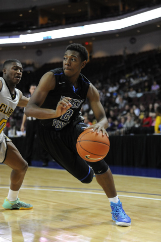 Desert Pines guard Jordan Simon (2) drives to the hoop while being guarded by Clark’s ...