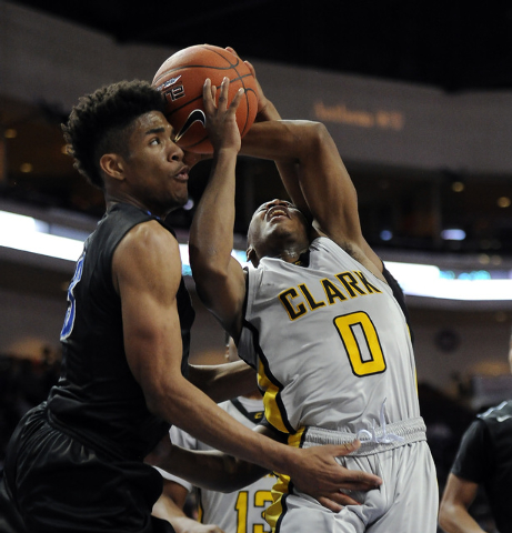 Clark guard Colby Jackson is fouled by Desert Pines point guard Coby Myles as Trevon Abdulla ...