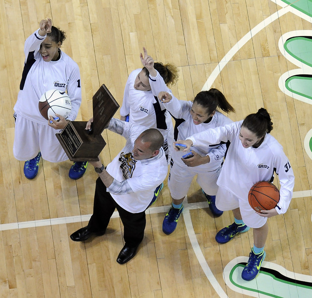 Spring Valley head coach Billy Hemberger, center, hoists the state championship trophy with ...