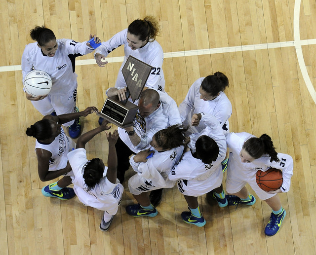 Spring Valley head coach Billy Hemberger, center, hoists the state championship trophy with ...