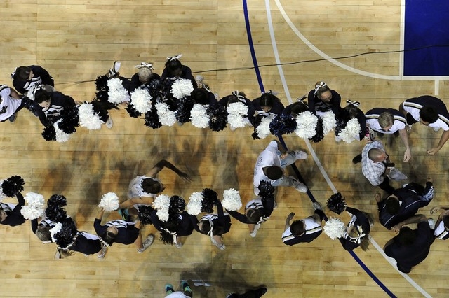 Spring Valley cheerleaders form a line as head coach Billy Hemberger, far right, and guard L ...