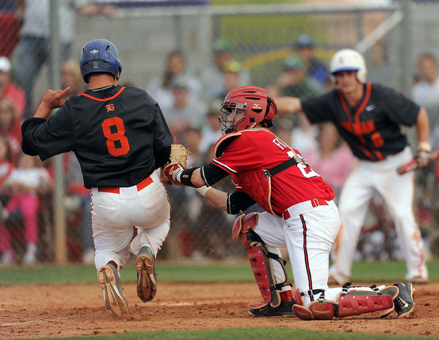 Arbor View catcher Joe Fitzhugh tags out Bishop Gorman base runner Daniel Edson (8) at home ...