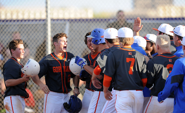 Bishop Gorman players swarm home plate after Brandon Wulff (blue helmet) hit a walk-off gran ...