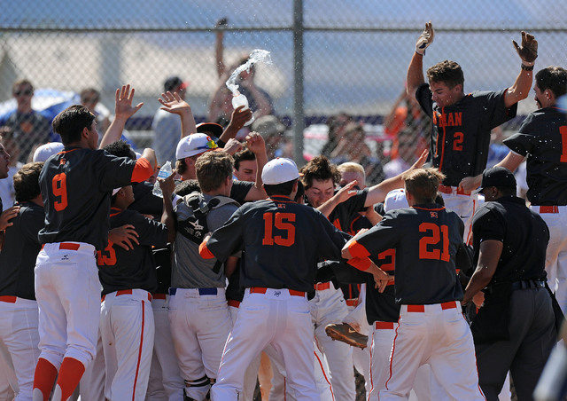 Bishop Gorman’s Cadyn Grenier, right, jumps into a pile of players waiting at home pla ...