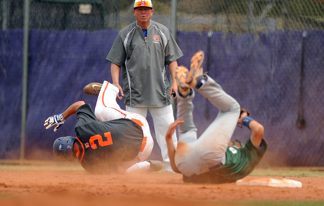 Green Valley first baseman Drake Maningo (9) collides with Bishop Gorman base runner Gadyn G ...