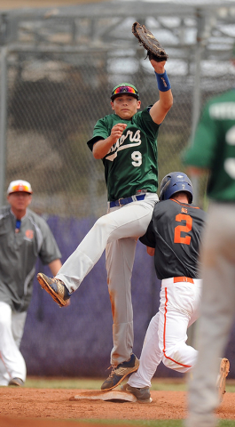 Green Valley first baseman Drake Maningo (9) collides with Bishop Gorman base runner Gadyn G ...