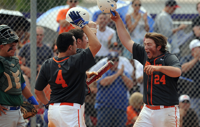 Bishop Gorman first baseman Austin Cram (24) high fives teammates home plate as catcher Ty B ...