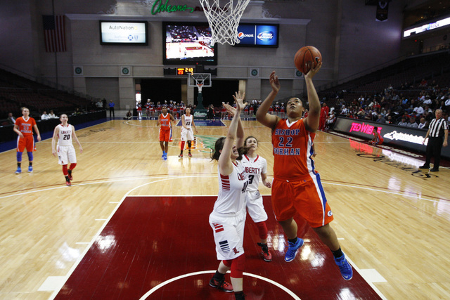 Bishop Gorman forward Raychel Stanley drives past Liberty forward Nancy Caballero for a layu ...