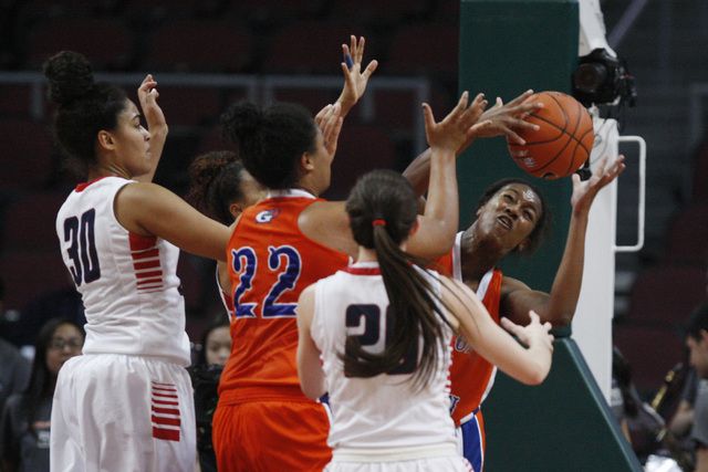 Bishop Gorman forward Madison Washington pulls down a rebound during the Division I state se ...