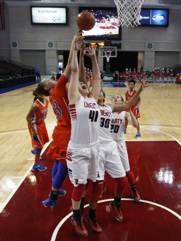 Bishop Gorman guard Megan Jacobs knocks a rebound away from Liberty forward Nancy Caballero ...