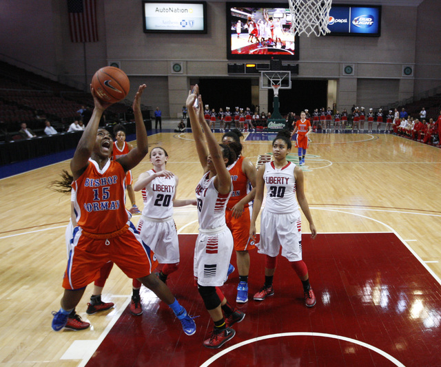 Bishop Gorman forward Madison Washington launches a shot over Liberty guard Aubre Fortner du ...