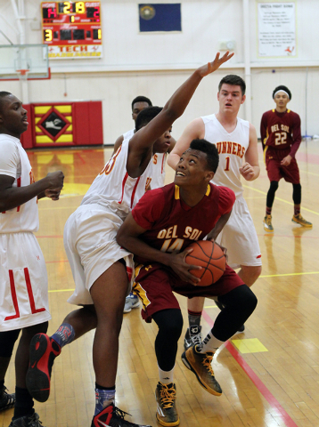 Del Sol forward Brian Greer (14) looks to shoot past Southeast Career Tech forward Sir-Isak ...