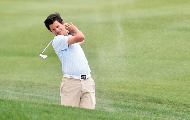 Foothill’s Noah MacFawn grimaces as sand blows back into his face after hitting out of ...