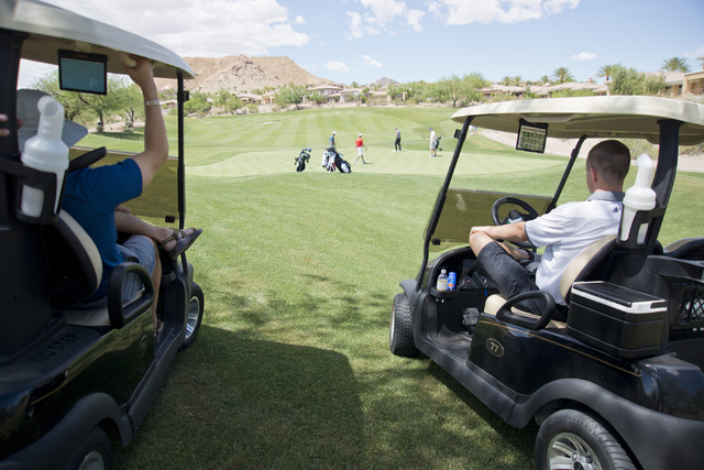 Parents and coaches watch during the Division I state boys golf tournament at the Reflection ...