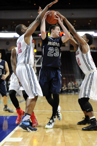 The Meadows School guard Jake Epstein (23) is surrounded byAgassi Prep forward Darius Coaxm, ...