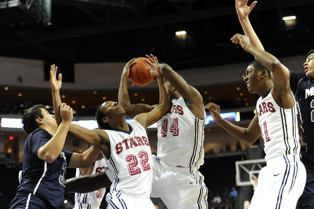 Agassi Prep forward Dennis Walker (44) pulls down a rebound as forward Jordan Smith (22) and ...