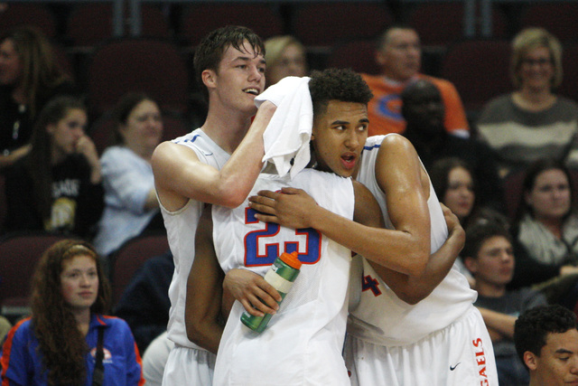 Bishop Gorman’s Stephen Zimmerman, Nick Blair and Chase Jeter embrace in the closing m ...