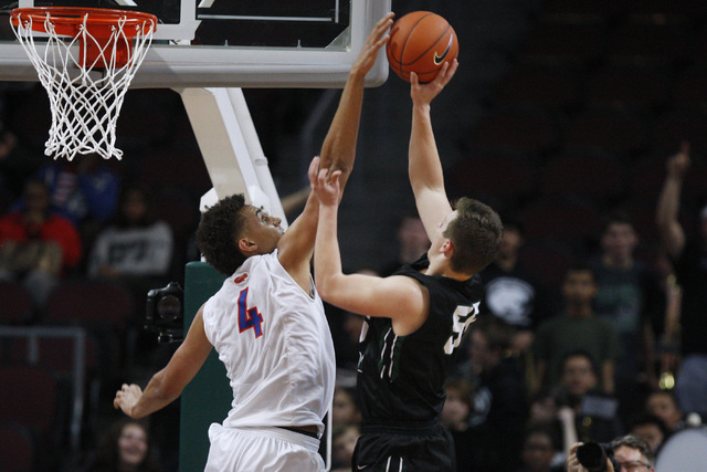 Bishop Gorman center Chase Jeter blocks a shot by Palo Verde forward Kyler Hack during their ...