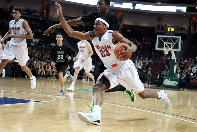 Bishop Gorman guard Nick Blair is grabbed by Palo Verde forward Jamell Garcia-Williams durin ...