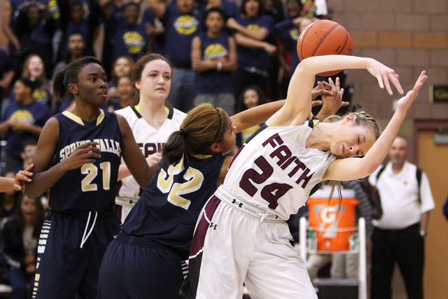 Spring Valley forward Lynnae Wilds and Faith Lutheran forward Morgan Hill both lose control ...