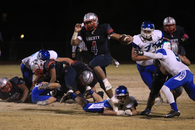 Liberty running back Ethan Tuilagi gets away from the Green Valley defense on Friday. Tuilag ...