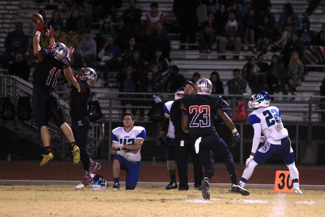 Liberty defensive back Preston Pavlica intercepts a pass intended for Green Valley wide rece ...