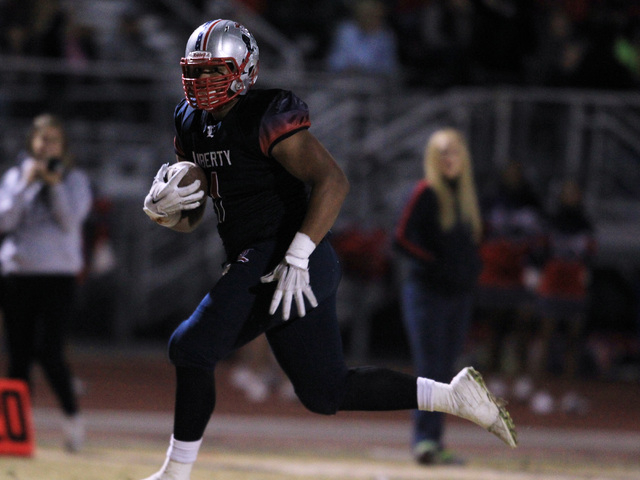 Liberty tight end Noah Jefferson heads to the end zone as he scores against Green Valley on ...