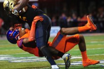 Bishop Gorman safety Greg Francis, bottom, tackles St. Thomas Aguinas, Fla. wide receiver Jo ...