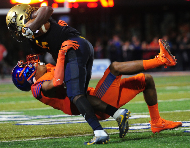 Bishop Gorman safety Greg Francis, bottom, tackles St. Thomas Aguinas, Fla. wide receiver Jo ...