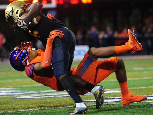 Bishop Gorman safety Greg Francis, bottom, tackles St. Thomas Aguinas, Fla. wide receiver Jo ...