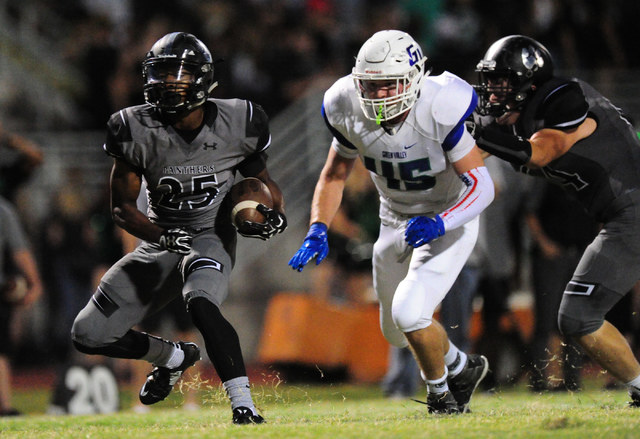 Palo Verde running back Terrill Jimerson looks for running room as Green Valley linebacker B ...