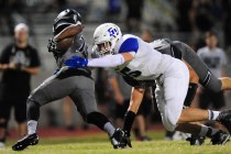 Green Valley linebacker Brock Hershberger tackles Palo Verde running back Terrill Jimerson ...