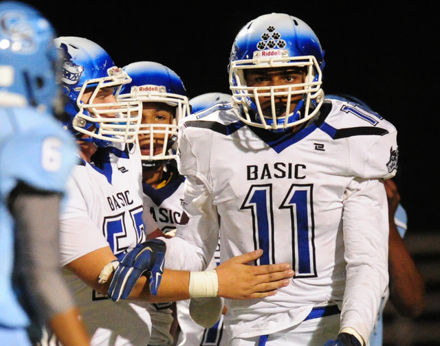 Basic High School players congratulates Basic wide receiver Harris Frank (11) after Frank sc ...