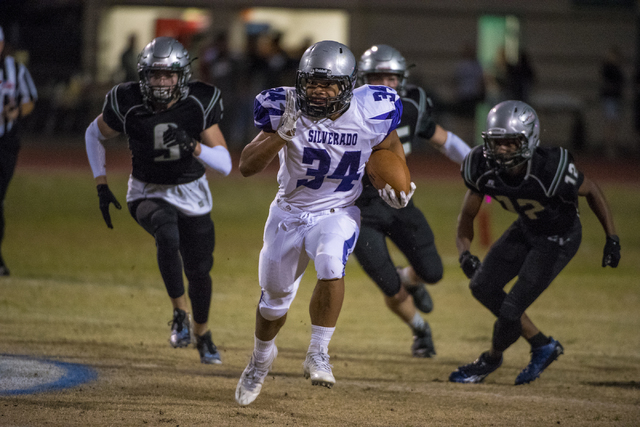 Silverado running back Keikiokalani Misipeka (34) runs with the ball as Green Valley defende ...