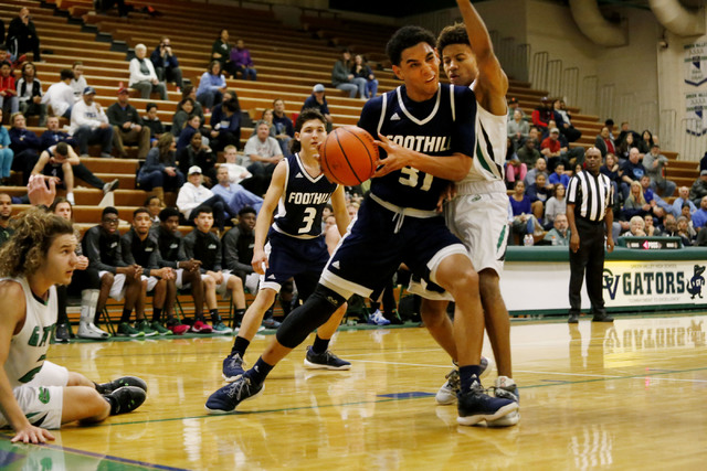 Foothill’s Marvin Coleman (31) looks for a shot during a high school basketball game a ...