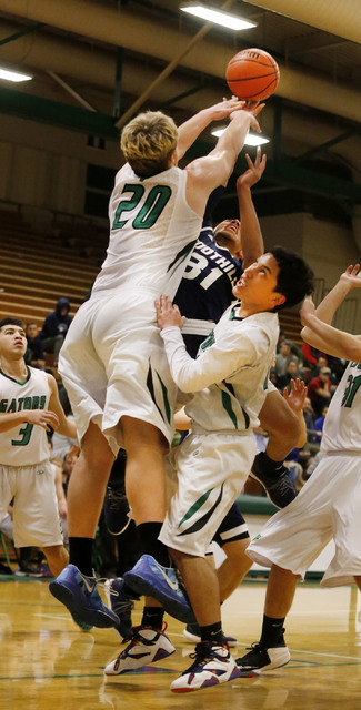 Foothill’s Marvin Coleman (31) reaches for a loose ball during a high school basketbal ...